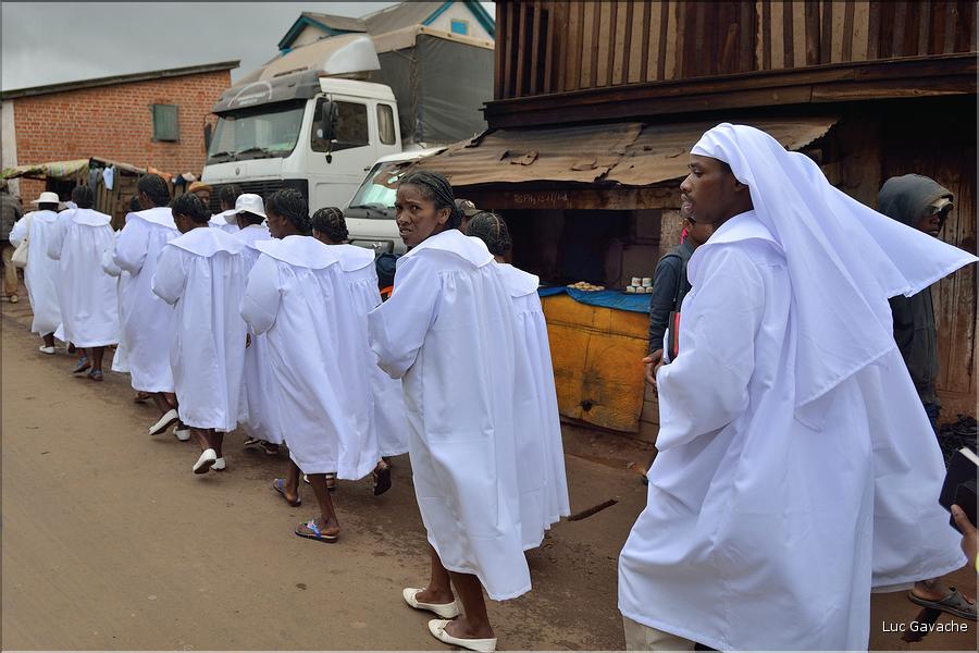 Sur la route entre Fianarantsoa et Ambositra se succéde les villages des hautes terres. Ici une procession religieuse. (24)
